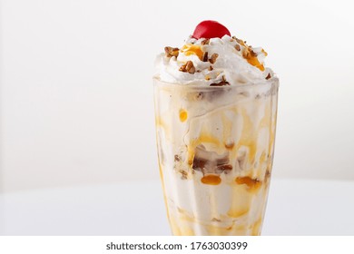 Caramel Pecan Ice Cream Sundae With Whipped And Cherry On Top