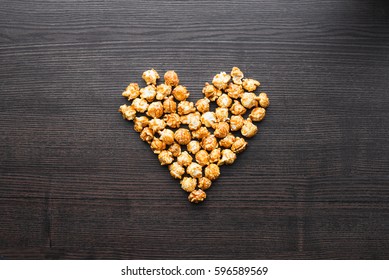 Caramel popcorn on the table, heart shaped