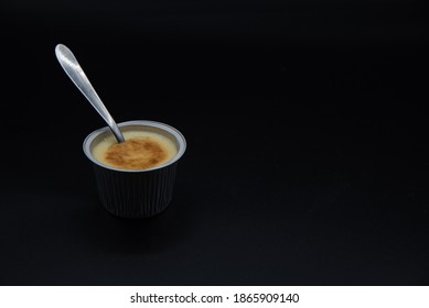 Crème Caramel
With Spoon On Black Background