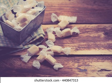 Caramel Toffee Candy In Metal Jar,wood Background
,vintage Color Toned Image