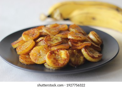 Caramelised Plantain Slices. A Traditional Tea Time Snack From Kerala.Cut Ripe Plantain Into Slices And Toast It In A Pan Adding Ghee N Some Brown Sugar. Shot On White Background.