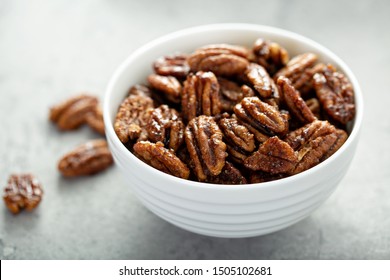 Caramelized or candied pecans for appetizer or salad in white bowl