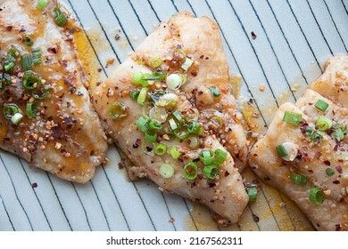 Caramelized catfish filets with chopped green onions