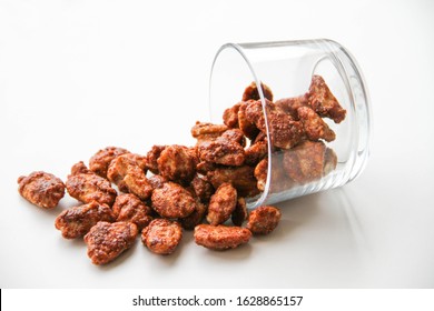 Caramelized Pecan Nuts In A Glass On A White Background, Back View