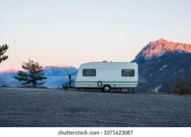 Caravan With A Bike Parked On A Mountaintop With A View On The French Alps Near Lake Lac De Serre-Poncon