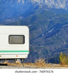 Caravan With A Bike Parked On A Mountaintop With A View On The French Alps Near Lake Lac De Serre-Poncon On A Bright Sunny Day