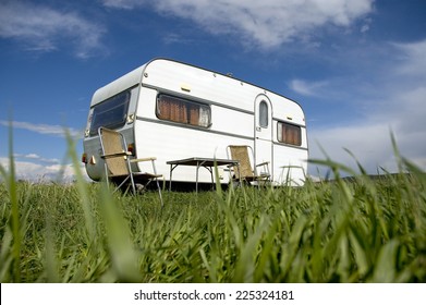 caravan camping with table and two chars