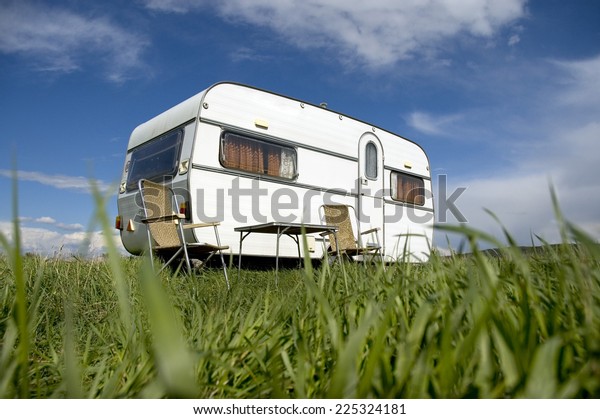 caravan-camping-with-table-and-two-chars