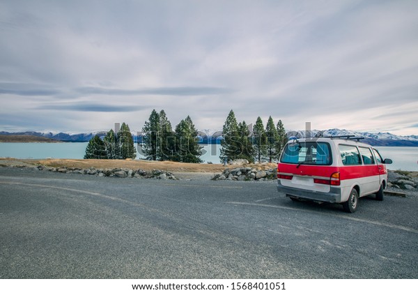A caravan car parking in a lookout\
point of Lake Tekapo, South Island, New\
Zealand