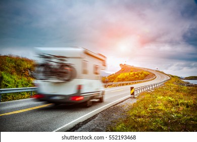 Caravan car travels on the highway. Caravan Car in motion blur. Norway. Atlantic Ocean Road or the Atlantic Road (Atlanterhavsveien) been awarded the title as "Norwegian Construction of the Century".