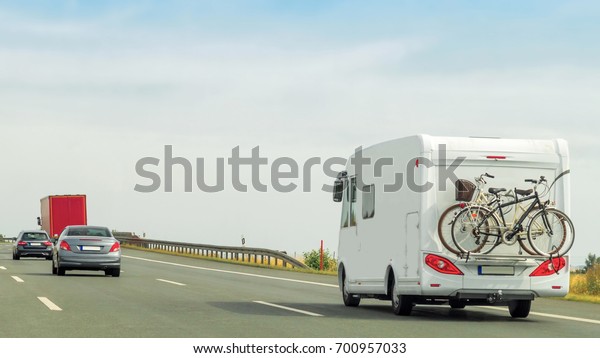 Caravan and cars\
on the motorway in\
Switzerland.