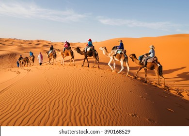Caravan going through the sand dunes in the Sahara Desert, Morocco - Shutterstock ID 390168529