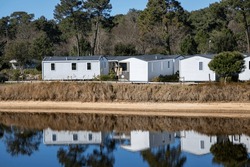 Caravan Mobilehome Park With Modern Caravans Mobile Home Prefabricated Structure In Camping House Trailer Aside Water Edge River
