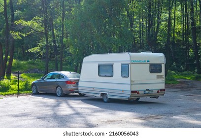 With Caravan On Vacation. Car Towing A Caravan. Romania, Polovragi. May, 22, 2022