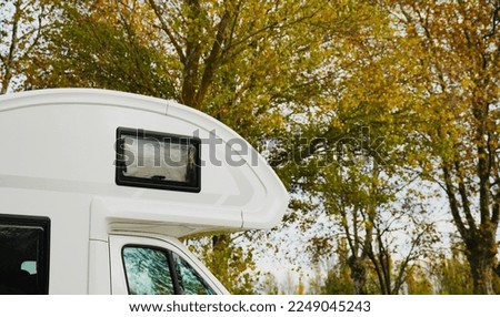 Caravan parked in the forest. Motorhome vacation.