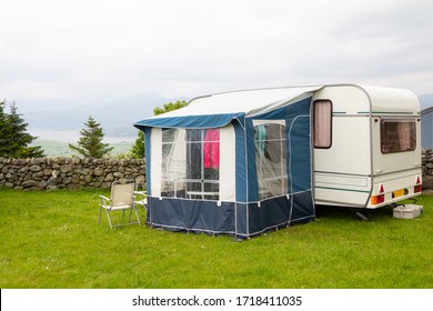 Caravan With A Porch Awning Set Up On  Camp Site Over Looking Estuary In Rural Wales UK 