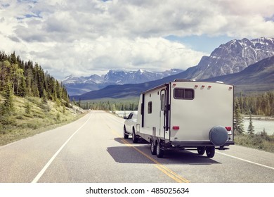 Caravan or recreational vehicle motor home trailer on a mountain road in Canada