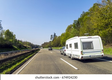 Caravan or recreational vehicle motor home trailer on a freeway road