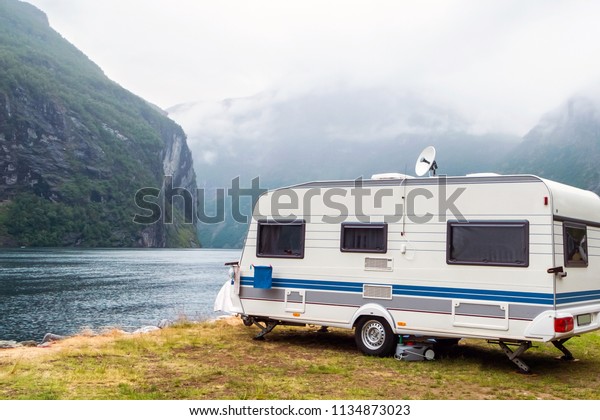 Caravan in a\
relaxing nature camp site at\
norway