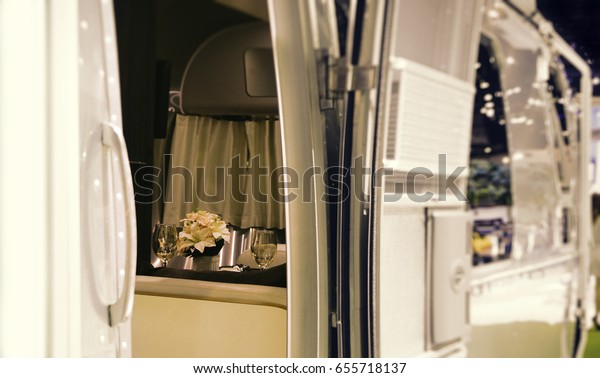 Caravan with a romantic atmosphere, flowers and 2\
glasses in a cozy caravan\
trailer