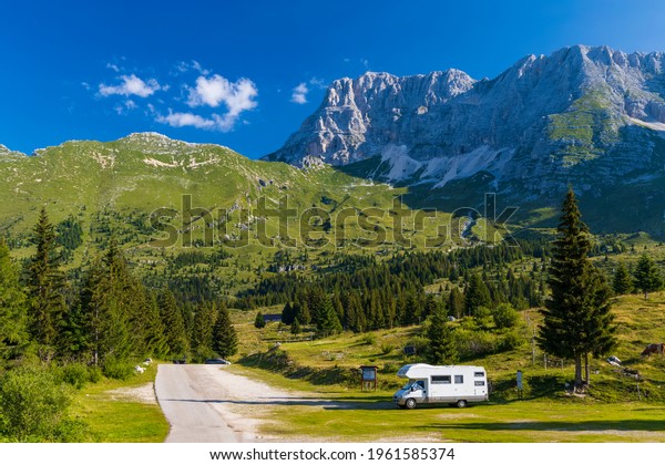 Caravan in\
summer mountain landscape, Alps,\
Italy