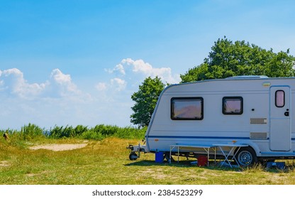 Caravan trailer camping on nature. Travelling, family vacation with mobile home.
