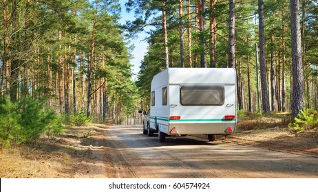 Caravan Trailer On A Forest Road, On A Sunny Spring Day