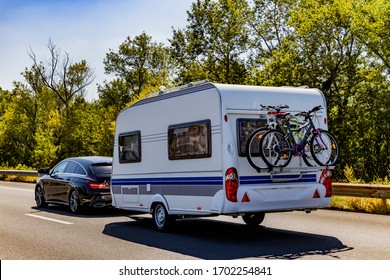 Caravan trailer on a freeway road.