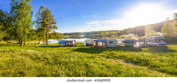 Caravans and camping on the lake. Family vacation outdoors, travel concept