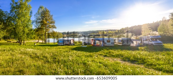 Caravans and camping on the lake. Family vacation\
outdoors, travel\
concept