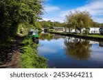 Caravans and narrow boats on the Leeds - Liverpool canal at Scarisbrick near Southport.