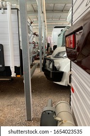 Caravans And Rv Vehicles Lined Up In Storage Facility Under Cover Of A Large Metal Shed