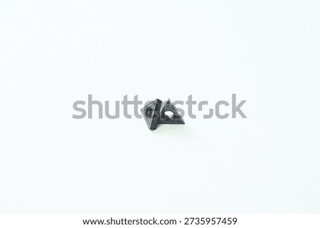 Carbide inserts showing sharp edges for precision cutting in manufacturing process.