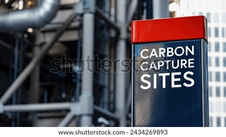 Carbon Capture Sites on a sign in front of an Industrial building	