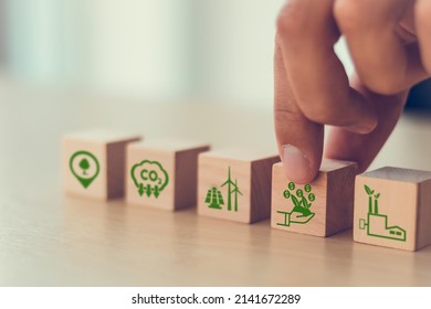 Carbon credit concept. Tradable certificate to drive industry and company in the direction of low emissions in efficiency cost.  Wooden cubes with CO2, US dollars and carbon offsetting solution icons. - Shutterstock ID 2141672289