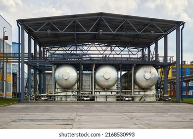 Carbon Dioxide Production Plant. Cryogenic CO2 Tank Carbonic Acid Distillation Storage. Part Of Petrochemical Plant Three Cryogenic Tanks With CO2 Under Canopy Heat Protection Export Filling Device.