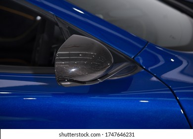 Carbon Fiber Mirror Cap On Blue Sports Car