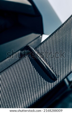 Carbon fiber rear spoiler viewed from above looking at the weave