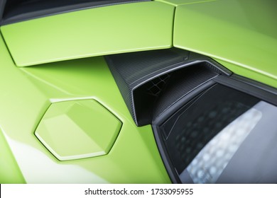 A carbon fibered exhaust of a green car