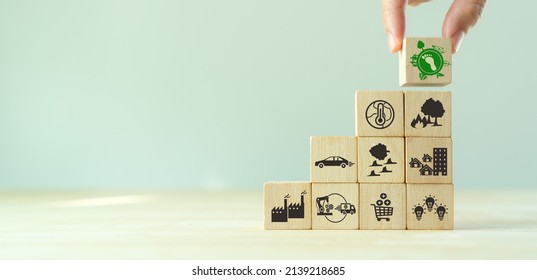 Carbon Footprint, Low Carbon Emission Concept. Climate Changing Problems Solving Goals. Stacking Wooden Cubes With Carbon Footprint Icon On Pollution Source Icons On Grey Background,copy Space. LCA.