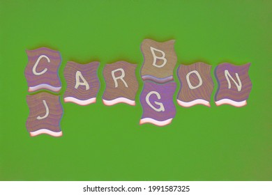 Carbon Jargon, words with effects added, in wooden alphabet letters isolated on green background as banner headline