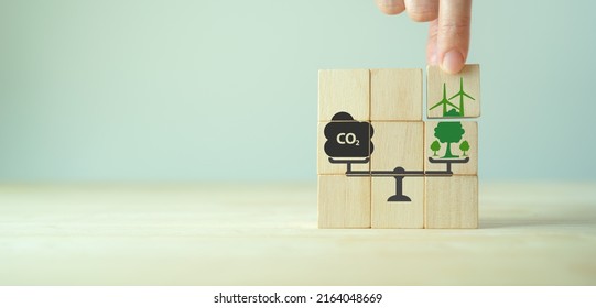 Carbon neutral balancing CO2 emission offset concept. Planting of trees and renewable energy to absorb CO2 in compensation of same amount produced. Carbon offset, limit climate change, global warming. - Shutterstock ID 2164048669