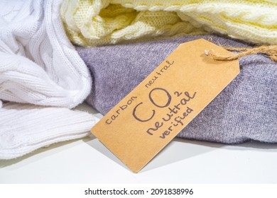 Carbon Neutral, CO2-free Concept Product. Natural Organic Cotton Clothing, With CO2 Neutral Tag Verified, On The Desk At Home Or In A Store