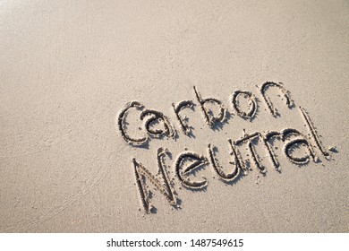 Carbon Neutral Message Handwritten On Smooth Sand Beach 