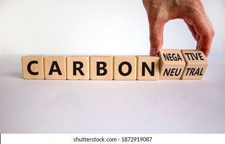 From Carbon Neutral To Negative. Hand Flips Cubes And Changes Words 'carbon Neutral' To 'carbon Negative'. Beautiful White Background, Copy Space. Business, Ecological And Carbon Negative Concept.