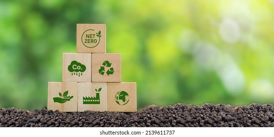 Carbon neutral and net zero concept natural environment Climate-neutral long-term strategy greenhouse gas emissions targets Wooden block with green net center icon - Shutterstock ID 2139611737
