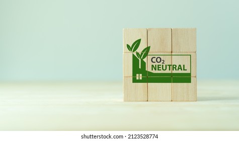 Carbon neutral sustainable development concept. Green industry. Net zero greenhouse gas emissions target 2050. Climate neutral long term strategy. Wooden cube with carbon neutral, green factory icon. 