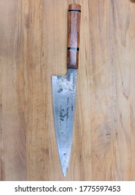 Carbon Steel Knife On A Bamboo Wood Cutting Board