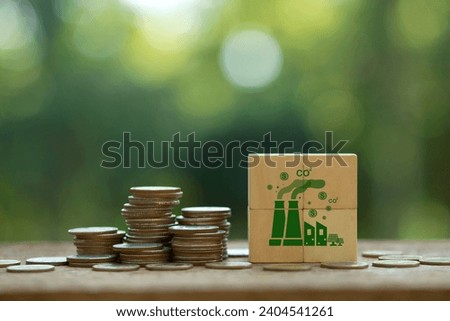 Carbon Tax, Tax on carbon emission. Coins stack with CO2 icons on wooden cubes for Environmental and social responsibility businesses. Taxation for nature pollution.Carbon credit.ESG fund, CO2 tax,