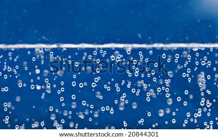 Carbonated water background with bubbles fizzling to the top.